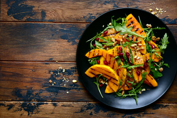 istock Grilled pumpking warm salad with arugula, walnuts and pomegranate seeds 1083844656