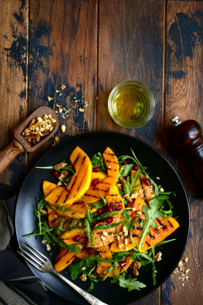 istock Grilled pumpking warm salad with arugula, walnuts and pomegranate seeds 1083844712