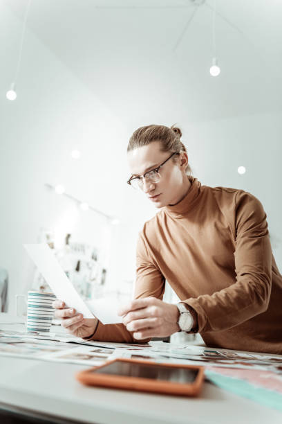 istock Handsome stylist from generation Y in eyewear looking concentrated 1083846808