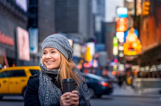 Female with coffee on Times Square in NYC.