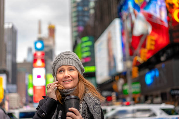 istock Female holding coffee and talking on mobile. 1083850174