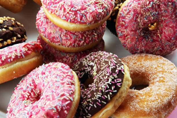 istock assorted donuts with chocolate frosted, pink glazed and sprinkles donuts 1083851212