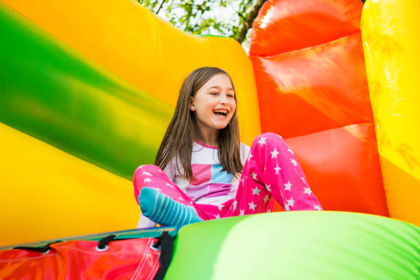 happy girl on play castle - inflatable child jumping leisure games imagens e fotografias de stock