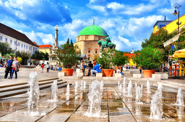 PECS , HUNGARY - SEPTEMBER 24, 2016: Szechenyi Square in Pecs with monuments and mosque-church museum and fountain.Pecs is the fifth largest city of Hungary, it is the administrative centre of Baranya