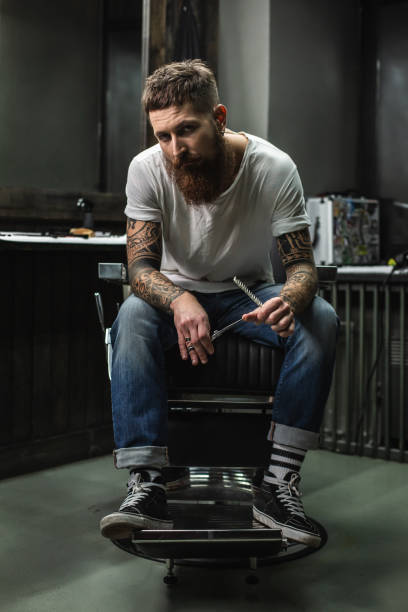 istock Confident barber sitting in armchair and looking 1083859440