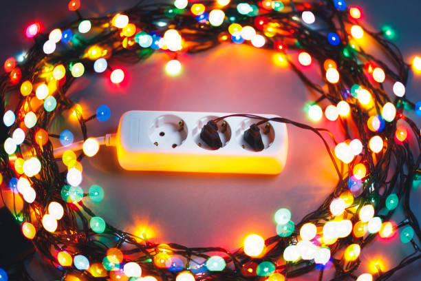 istock Christmas garland lights circle around electric extension cord 1083875470