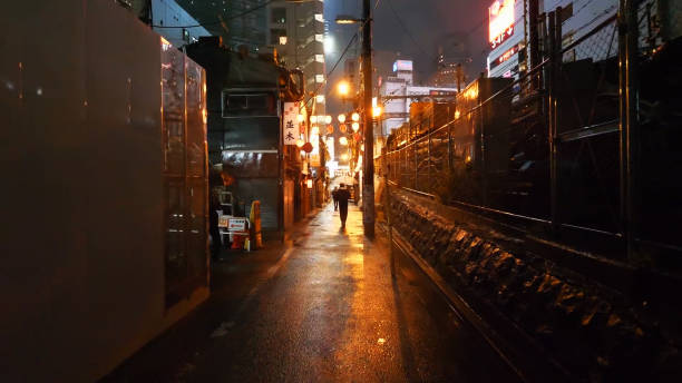 istock Illuminated Footpath Amidst Buildings At Night 1083878144
