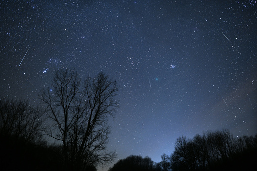 Clear, starry night seen on December 15, 2018 to the West of Madison, the capital City of Wisconsin. Green comet Wirtanen was clearly visible (near the center of picture) as well as dozens of Geminid meteors shooting across the dark sky. Orion constellation to the left and Pleiades star cluster near he comet.