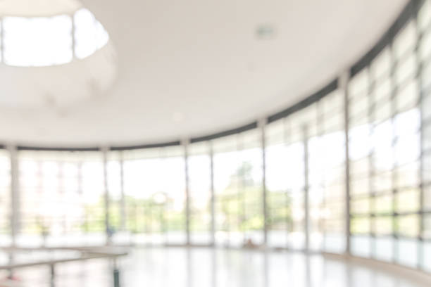 istock Blur background interior view looking out toward to empty office lobby and entrance doors and glass curtain wall 1083896072