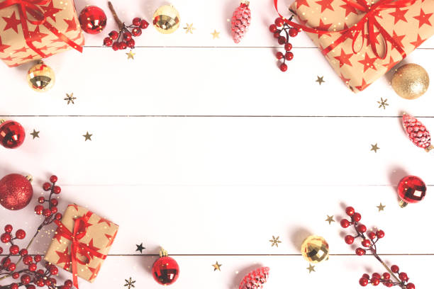 istock Christmas background with wrapped gift boxes and baubles on white wood. 1083899760