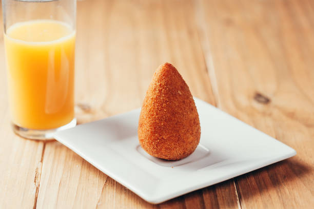 brazilian snack "coxinha" and orange juice on wood table - breadcrumb navigation imagens e fotografias de stock