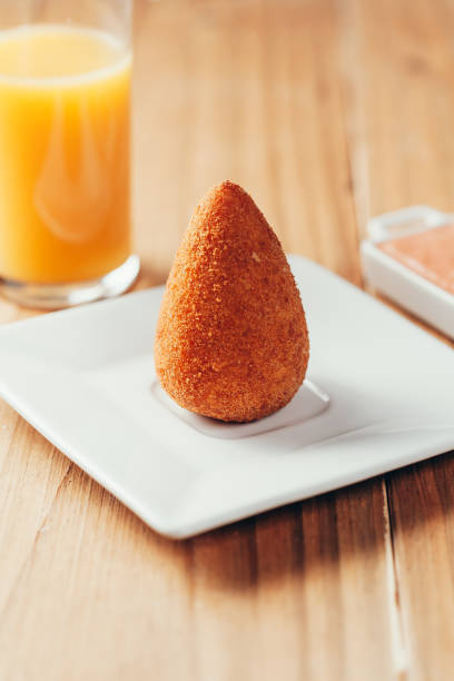 brazilian snack "coxinha" and orange juice on wood table - breadcrumb navigation imagens e fotografias de stock