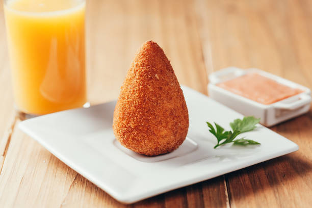 brazilian snack "coxinha" and orange juice on wood table - breadcrumb navigation imagens e fotografias de stock