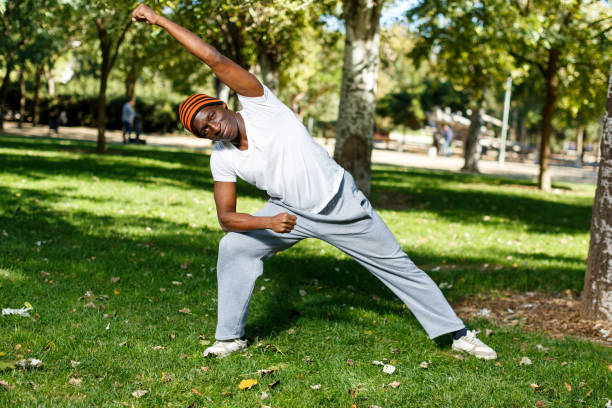 istock Active african  american man doing exercises for legs, workout in park 1083901146