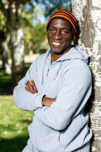 istock Athletic african  american male standing  near tree before training in park 1083901178
