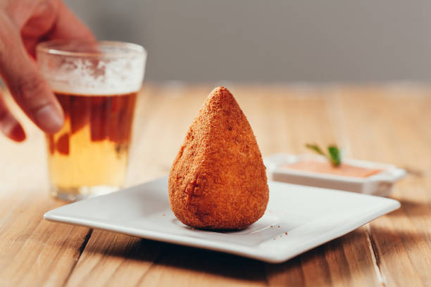 brazilian snack "coxinha" and beer on wood table - breadcrumb navigation imagens e fotografias de stock