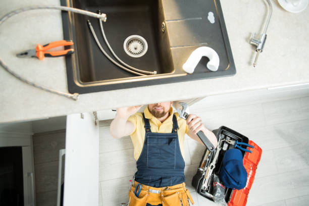 istock Plumber repairing pipe in kitchen 1083903768