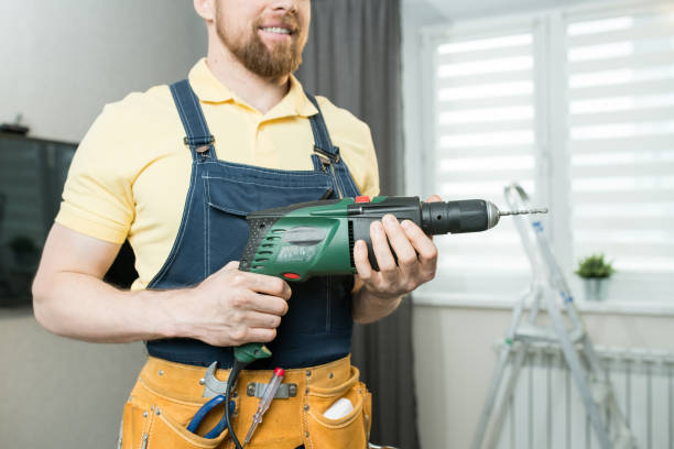 istock Repairman holding electric drill 1083903848