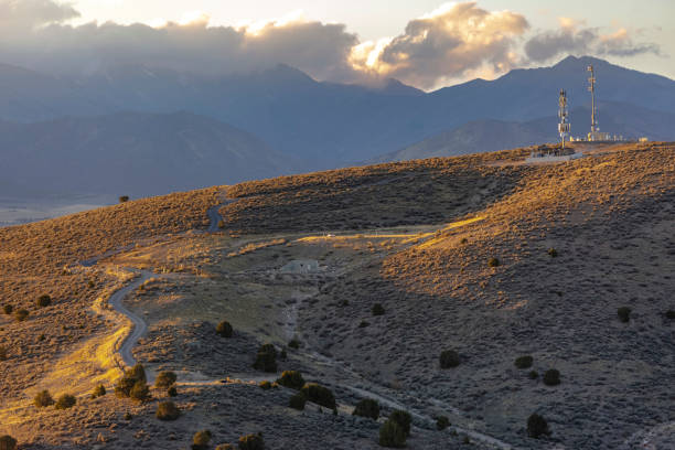 istock Antenna on a hill with clouds and mountain behind 1083910222