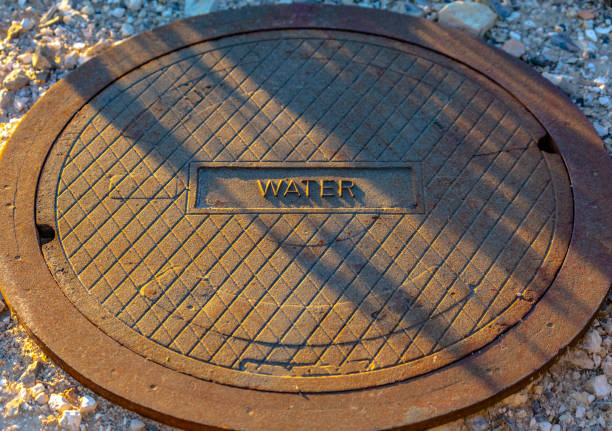 istock Man hole lid with label of water on the front 1083910238