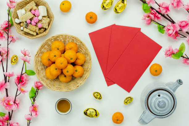 Chinese language mean rich or wealthy and happy.Top view decoration Chinese new year & lunar new year holiday background concept.Flat lay orange with pink flower on white wooden at home office desk. stock photo