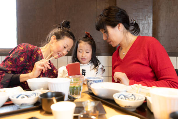 istock Friends and child eating lunch 1083930056