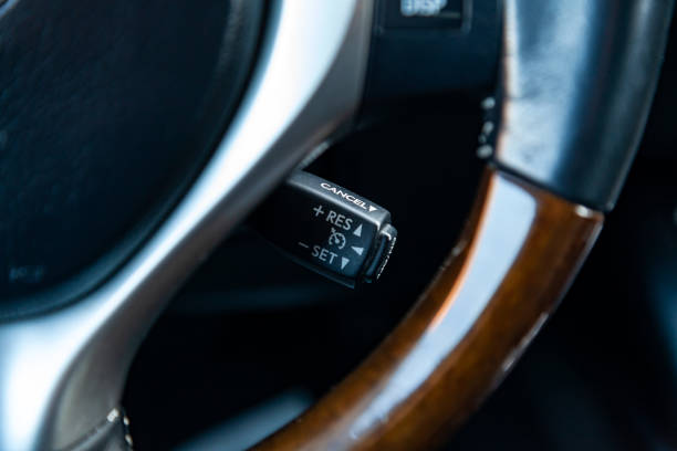 istock The shift lever to set the automatic cruise control speed inside the car close-up located near the steering wheel in black with white signs and symbols of beautiful design in the interior. 1083930364