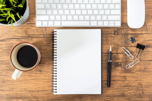 istock Top view, empty notebook and office supplies on the desk. 1083930690