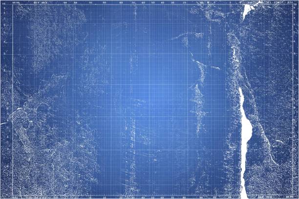 Torn up graph paper sheet in a  notebook. Blurred blue abstract background. stock photo