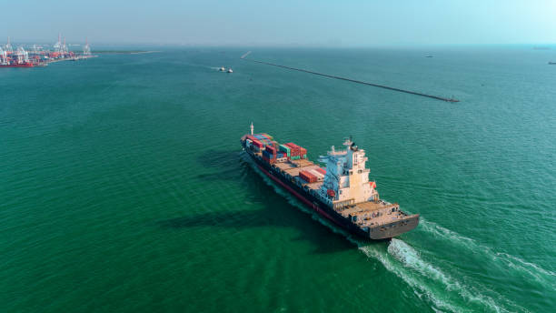 istock Aerial view container ship going to sea port for unload container for import export, shipping or transportation concept. 1083933618