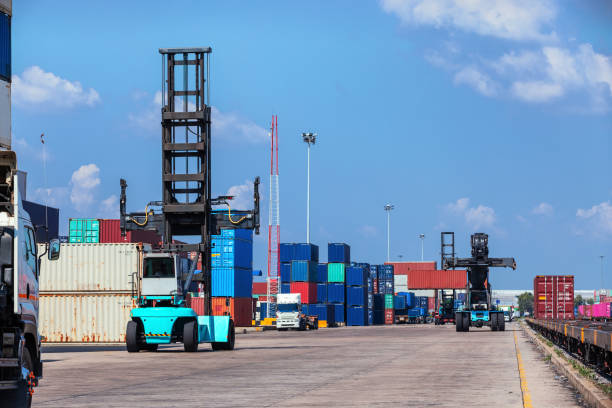 istock Forklift truck working in container warehouse with beautiful sky for logistics shipping, import export or transportation. 1083933778