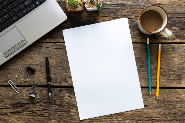 istock blank paper and pencils on old wooden table 1083935872