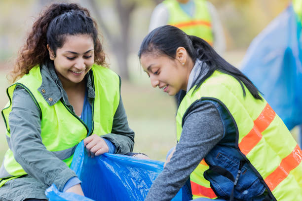 istock Two female friends enjoy volunteering together 1083936330