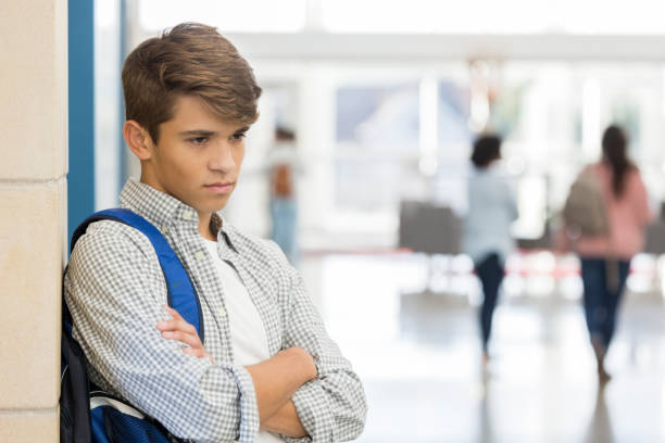 istock Angry male high school student stands in lobby 1083937428