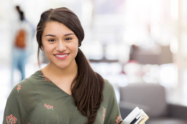 istock Cheerful female high school student smiles for camera 1083937432