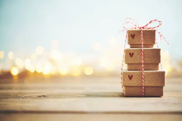 Photo of Cute gift stack with Christmas trees and Christmas lights