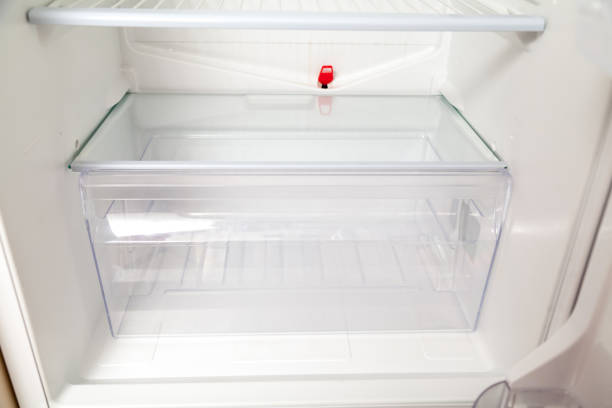 istock transparent box stands bottom of  empty refrigerator 1083955200