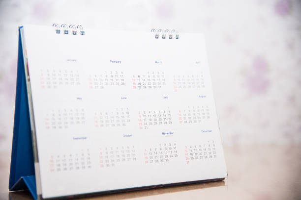 istock Blurred calandar on blue background in new years concept. 1083958452