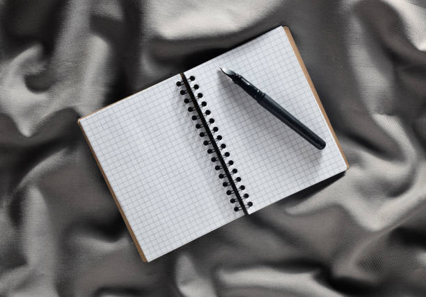 istock Notepad and pen on a gray fabric background. Top view 1083970936