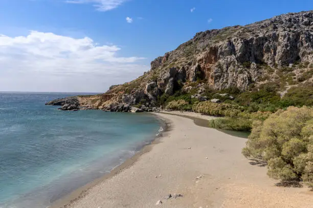 Landscape at Preveli beach on the island of Crete, Greece with a wide view over the mountains with a bay and a beach in the front