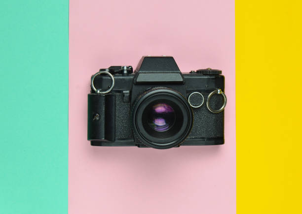 istock Retro camera on a colored paper background, flat lay, top view, minimalistic trend. 1083971100