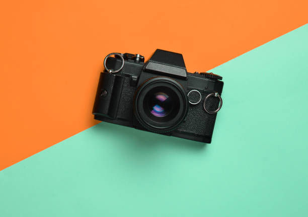 istock Retro camera on a colored paper background, flat lay, top view, minimalistic trend 1083971434