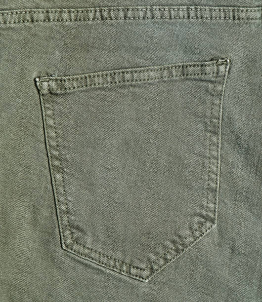 istock Green denim texture. Back pocket of the jeans 1083976102