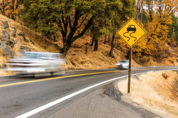 High quality stock photo of the beginnings of a mountainous pass on a winding highway.