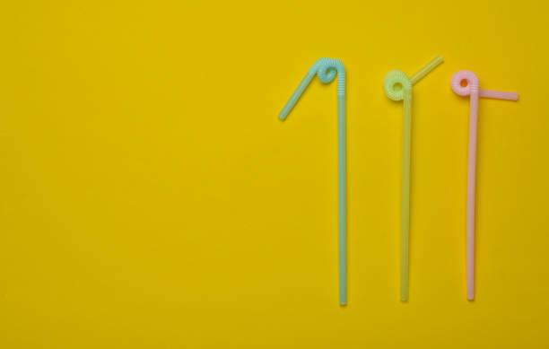 istock Colored cocktail tubes on a yellow pastel background. Top view. Copy space. Minimalist trend 1083979056