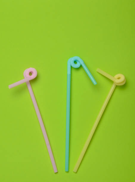 istock Colored cocktail tubes on a green pastel background. Top view. Copy space. Minimalist trend. 1083979062