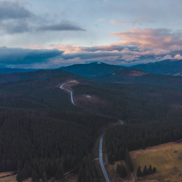 istock aerial view of highway in mountains on sunset 1083981750