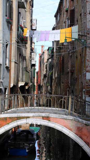istock clothes hanging over the waterway and Venice and an ancient brid 1083986678