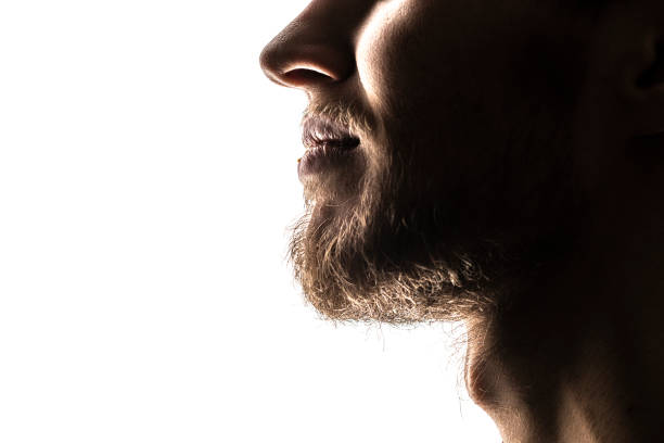istock close up man's face with beard, dark silhouette isolated f 1083987452
