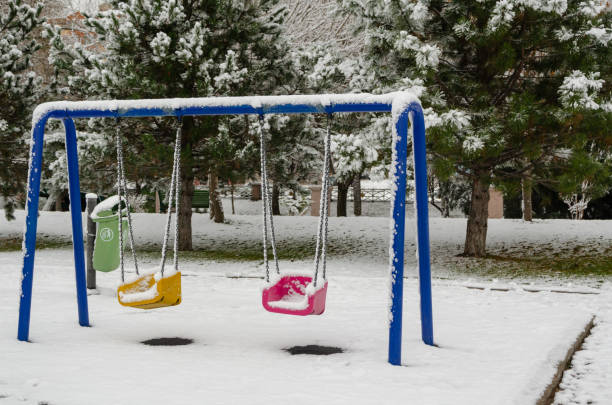 istock Winter landscape  with snow covered trees and swings 1083989796